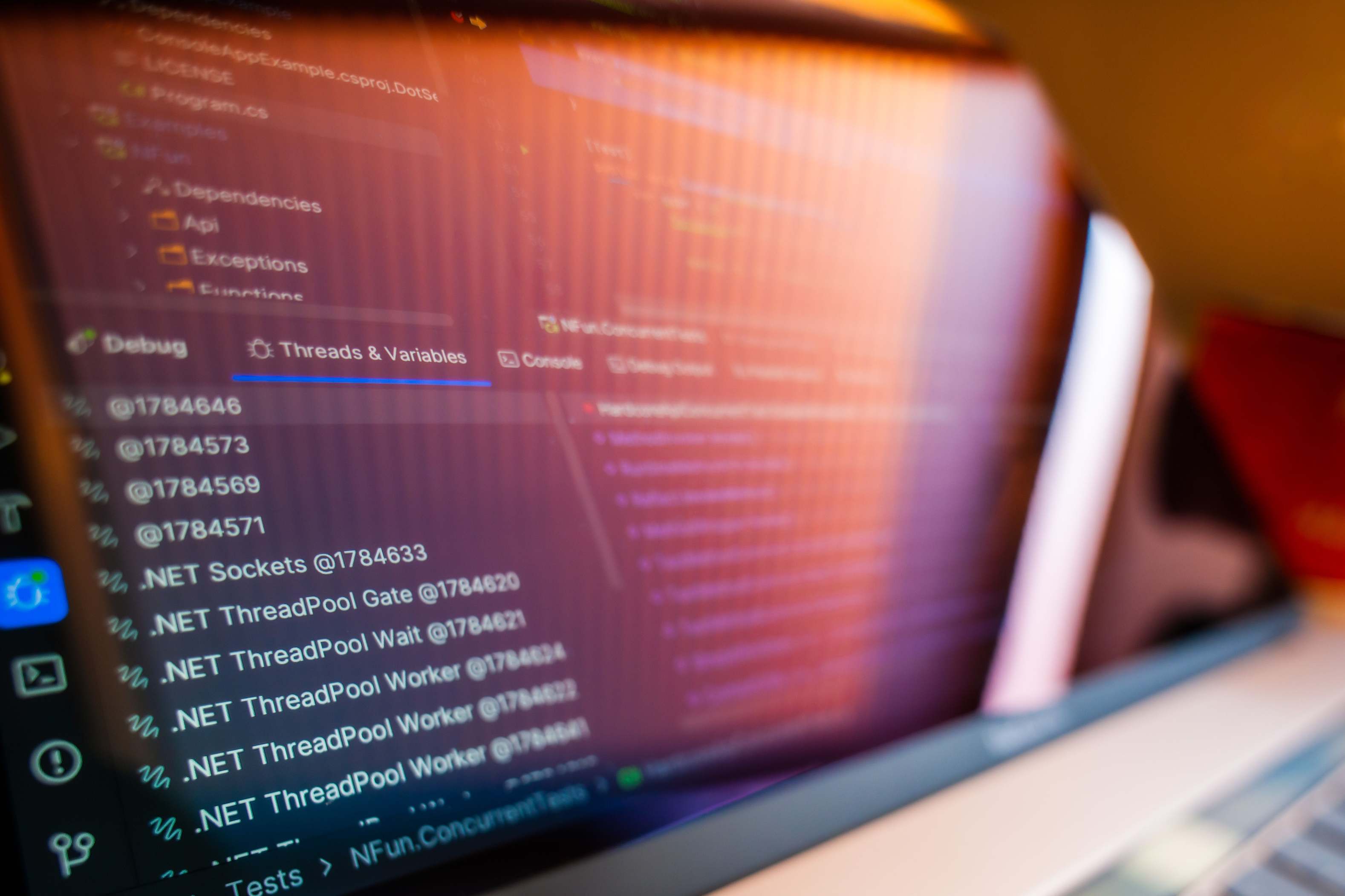 Developer reviewing code on a screen at close range with debug information visible